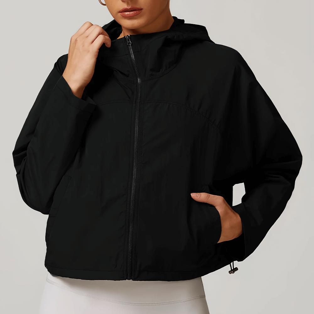 Lightweight brown hooded jacket for women with adjustable drawcord hem, perfect for activewear or casual outdoor activities.